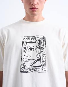 Model wearing Relaxed fit t-shirt with front and back Mothers Keeper print in ecru