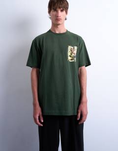 Model wearing Relaxed fit t-shirt with front and back watercolour shapes print in dark green