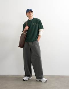 Model wearing Relaxed fit t-shirt with monsieur front and back embroidery in dark green
