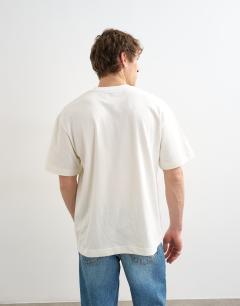 Model wearing Relaxed fit t-shirt with things are looking up embroidery in ecru