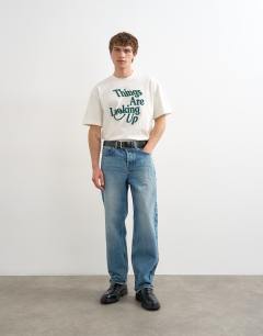Model wearing Relaxed fit t-shirt with things are looking up embroidery in ecru