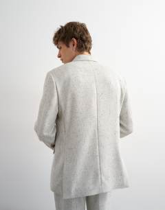 Model wearing Relaxed fit textured boucle blazer in cream