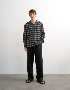 Model wearing Relaxed fit textured check revere shirt in black