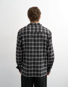 Model wearing Relaxed fit textured check revere shirt in black