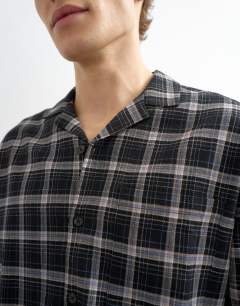 Model wearing Relaxed fit textured check revere shirt in black