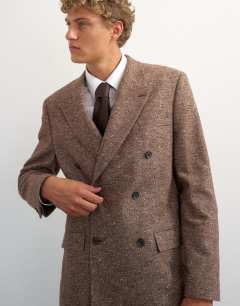 Model wearing Relaxed fit textured double breasted blazer in brown