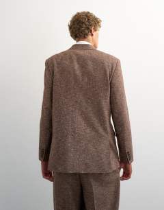 Model wearing Relaxed fit textured double breasted blazer in brown