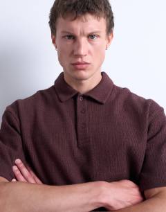 Model wearing Relaxed fit textured interlock polo in brown