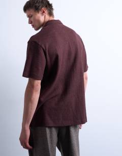 Model wearing Relaxed fit textured interlock polo in brown