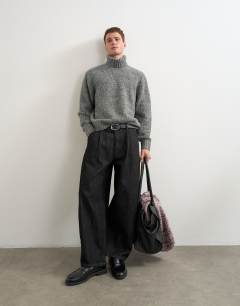 Model wearing Relaxed fit textured roll neck knitted jumper in charcoal