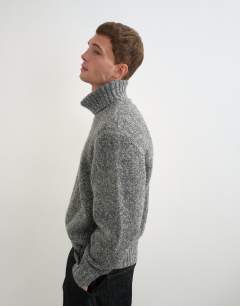 Model wearing Relaxed fit textured roll neck knitted jumper in charcoal