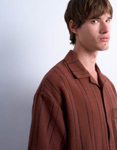 Model wearing Relaxed fit textured stripe button through polo in brown