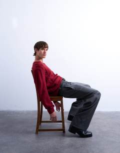 Model wearing Relaxed fit v neck cable jumper in red