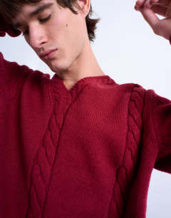 Model wearing Relaxed fit v neck cable jumper in red