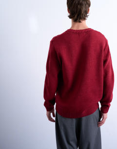 Model wearing Relaxed fit v neck cable jumper in red