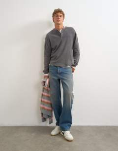 Model wearing Relaxed fit waffle henley with raw hem in washed black