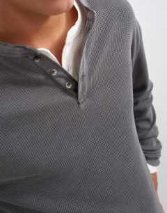 Model wearing Relaxed fit waffle henley with raw hem in washed black