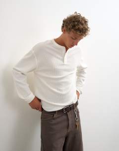 Model wearing Relaxed fit waffle henley with raw hem in washed ecru