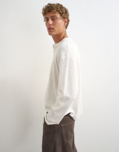 Model wearing Relaxed fit waffle henley with raw hem in washed ecru