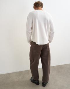 Model wearing Relaxed fit waffle henley with raw hem in washed ecru