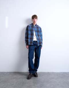 Model wearing Relaxed fit washed check shirt in blue