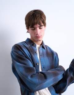 Model wearing Relaxed fit washed check shirt in blue
