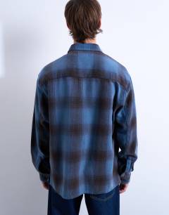 Model wearing Relaxed fit washed check shirt in blue