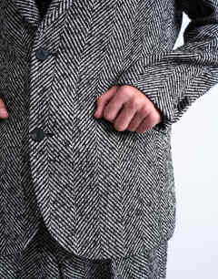 Model wearing Relaxed herringbone wool blazer in black