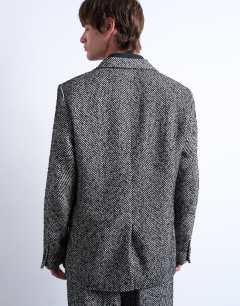 Model wearing Relaxed herringbone wool blazer in black