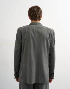 Model wearing Relaxed pinstripe double breasted suit jacket in charcoal