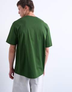 Model wearing Relaxed Shibuya print t-shirt in dark green