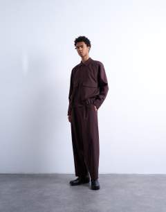 Model wearing Relaxed tapered trousers in burgundy