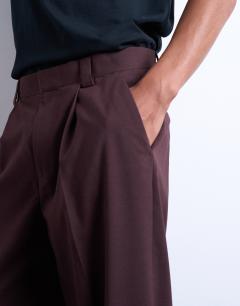 Model wearing Relaxed tapered trousers in burgundy