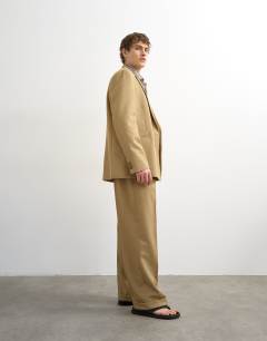 Model wearing Relaxed twill suit trousers in beige