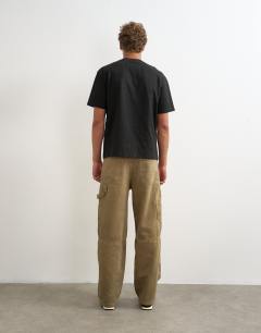 Model wearing Rigid baggy fit carpenter jean in tan