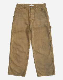 Model wearing Rigid baggy fit carpenter jean in tan