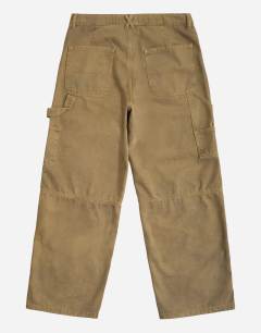 Model wearing Rigid baggy fit carpenter jean in tan