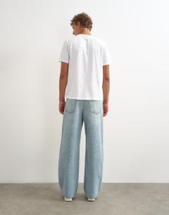Model wearing Rigid baggy fit distressed jean in light wash