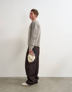 Model wearing Rigid baggy fit jean in raw brown
