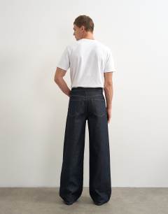 Model wearing Rigid baggy fit jean in raw