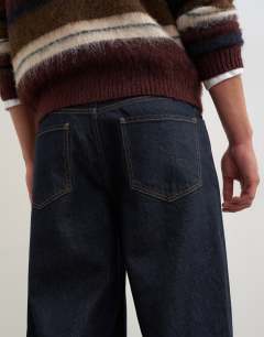 Model wearing Rigid baggy fit jean in rinse wash