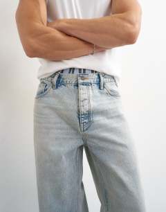 Model wearing Rigid baggy fit jean with turn-up in light wash