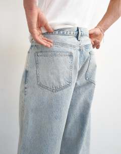 Model wearing Rigid baggy fit jean with turn-up in light wash