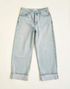Model wearing Rigid baggy fit jean with turn-up in light wash