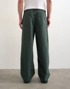 Model wearing Rigid baggy jean in green