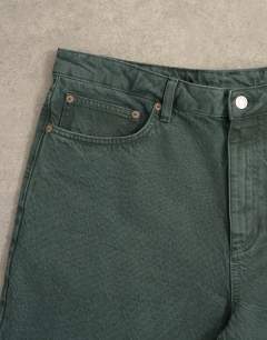 Model wearing Rigid baggy jean in green