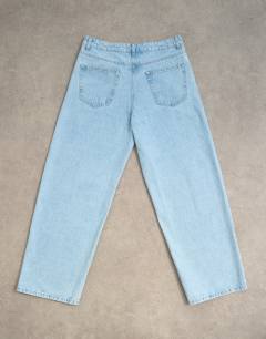 Model wearing Rigid baggy jean in light wash