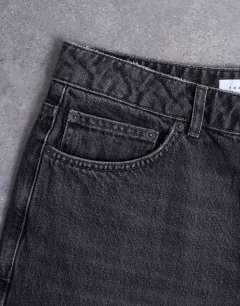 Model wearing Rigid baggy jean in washed black