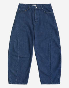Model wearing Rigid barrel fit jean in dark wash