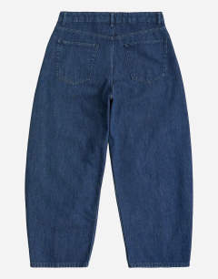 Model wearing Rigid barrel fit jean in dark wash
